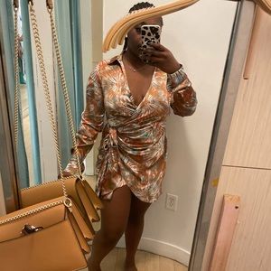 Silk abstract dress with low neckline and slit.